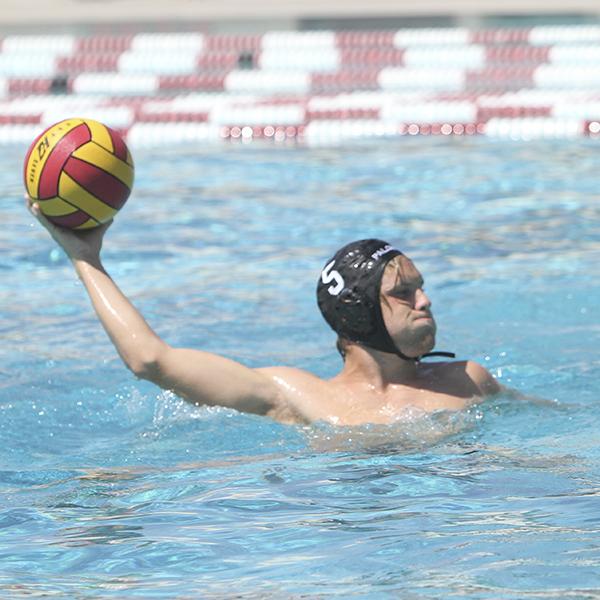 A male Palomar water polo player throws a ball with his right hand.