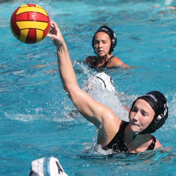 Palomar water polo player Sydney Thomas throws a ball with her right hand as a teammate in the background watch.