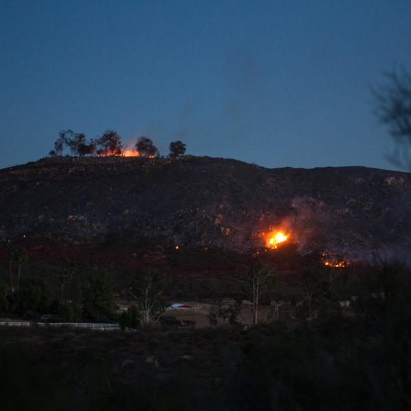 A structure at the top of the hill and hillside brush burn at the end of the day during the Liberty Fire, Dec. 8, 2017. (Savhanna Vargas/The Telescope)