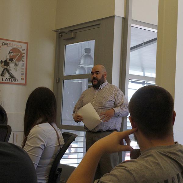 Bookstore Manager Ramon Rey and assistant manager Candace Tan present the new gym towels during the ASG meeting on Friday, Feb. 9, 2018. (Amanda Raines/The Telecope)