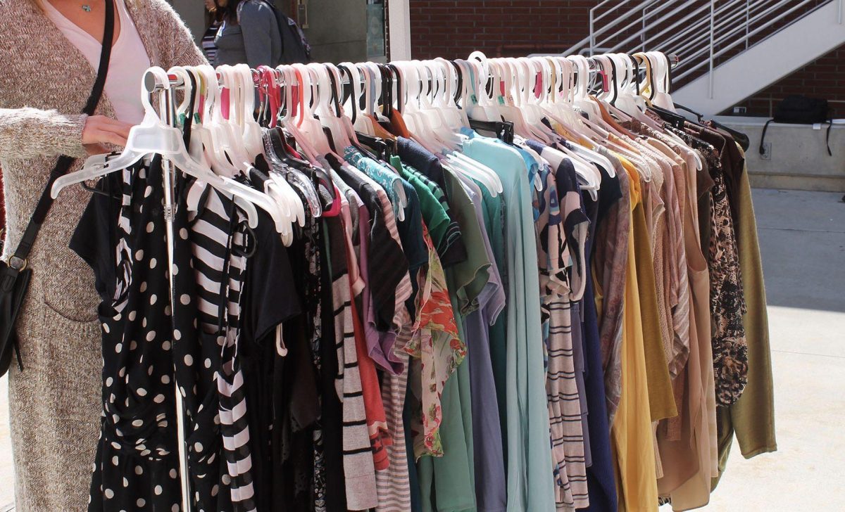 Student Madelyn Dorin browses through the women’s rack at the Comet’s Closet. (Megan Lammott/The Telescope)