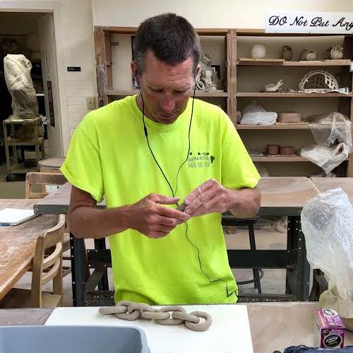 Jackson working on a chain link clay piece. Sundae Velasco/The Telescope.