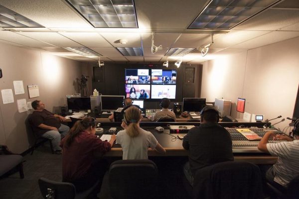 A group of people working at a TV broadcast studio.