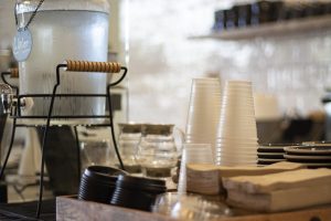 cafe area with cups water lids and napkins