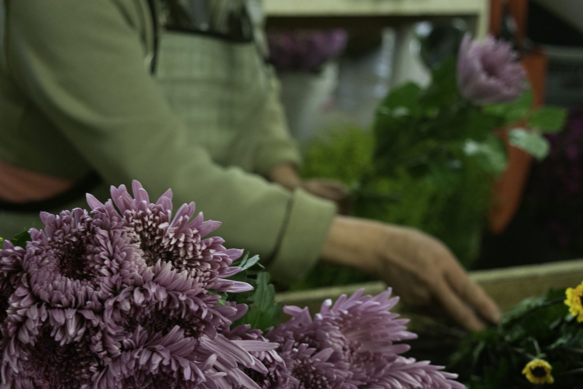 purple flowers laid next to Kendall Farms worker