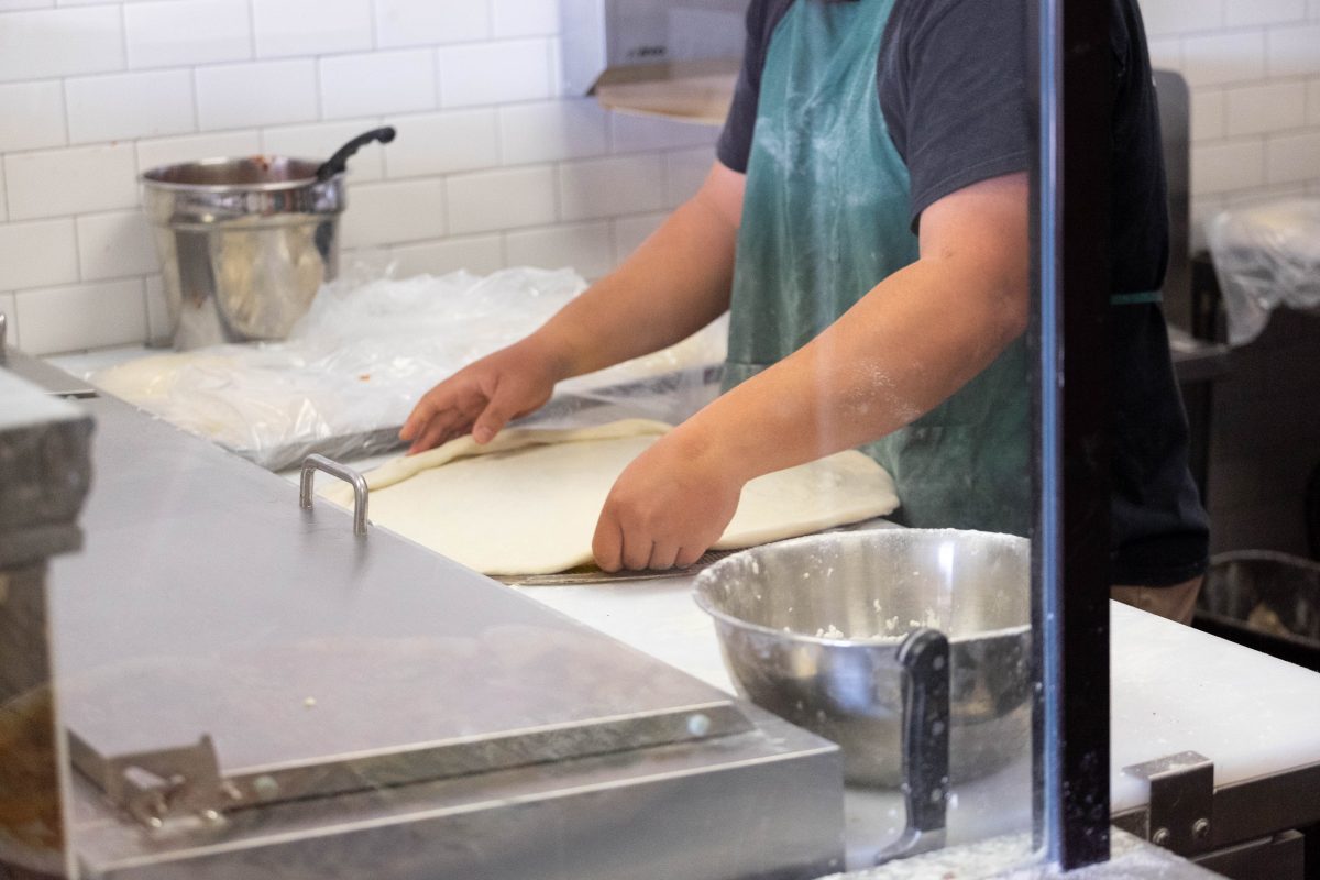 Pizza Maniac worker preparing pizza