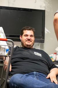 Pizza Maniac owner Ben Phillips sitting down