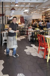 Host Michele Auriemma welcoming guests into Solunto Restaurant & Bakery in Little Italy.