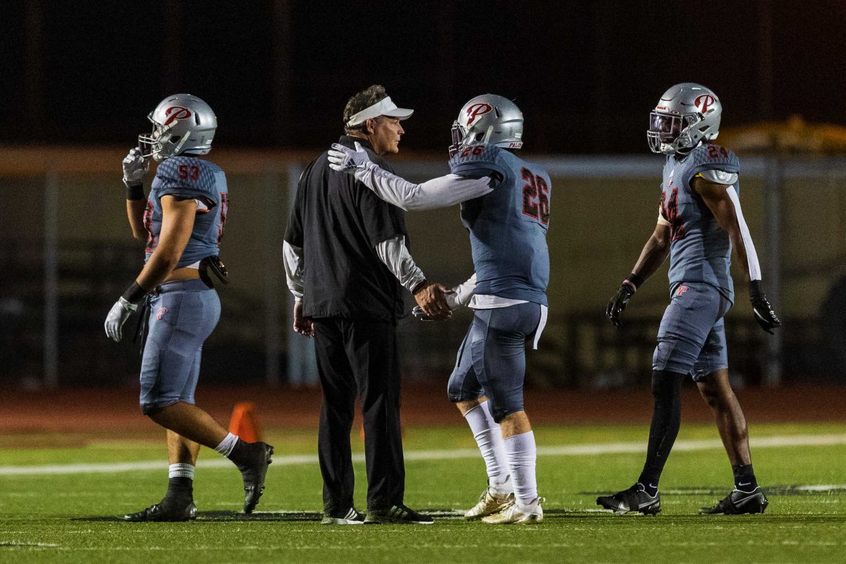 A Palomar football player greets a coach during an October football game. (Kevin Mijares/The Telescope)