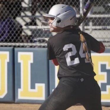 A female, Palomar softball player (24) gets read for bat.