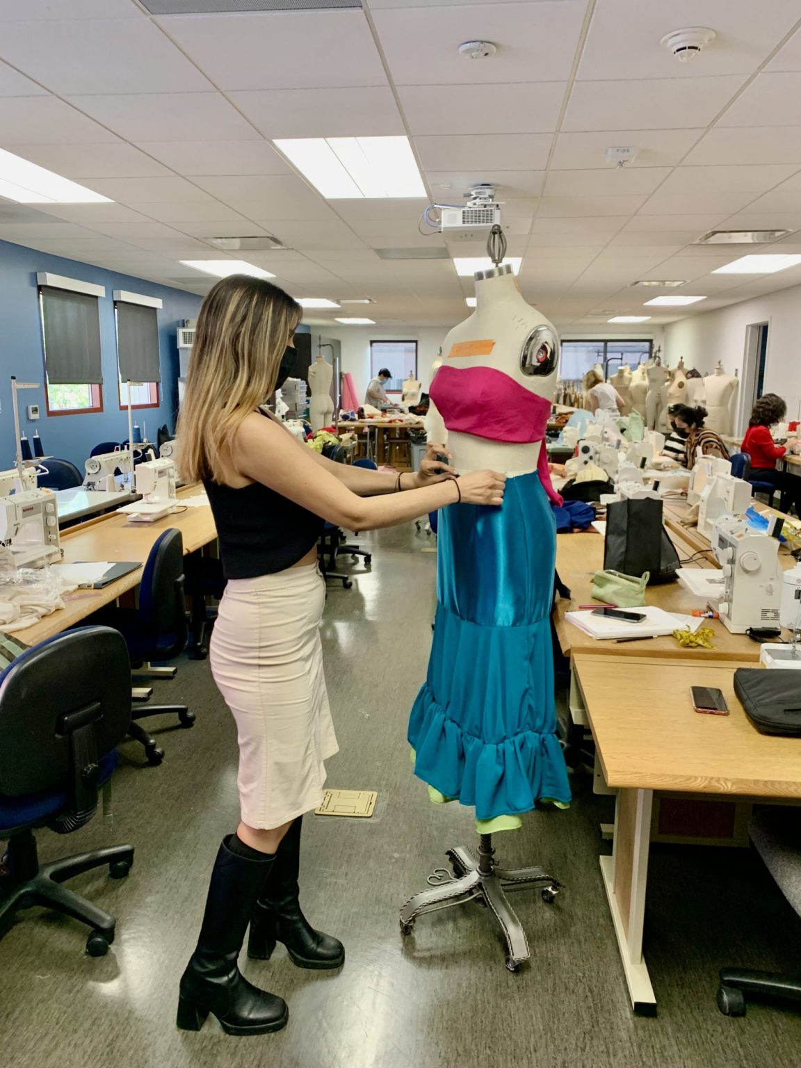 Alexis Solorio adjusts her design for the 2022 MODA Fashion Show. (Sophia Partida/IMPACT Magazine)