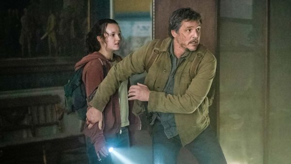 Actor Pedro Pascal stands in front of actress Bella Ramsey as if protecting her in a scene from "The Last of Us"