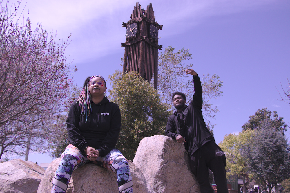 Umoja Club president Eric ’Trey“ Russel (r) and council representative Chanti Turner enjoy the midday sun near Palomar College’s clock tower. (Photo by Trina McLeary)