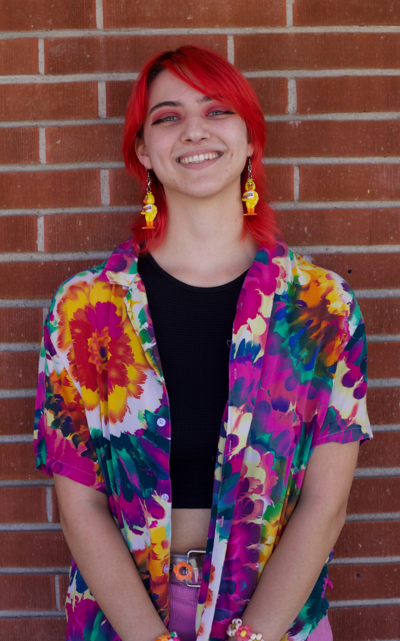 Palomar Student Chloe Saye stannds in front of a brick building.