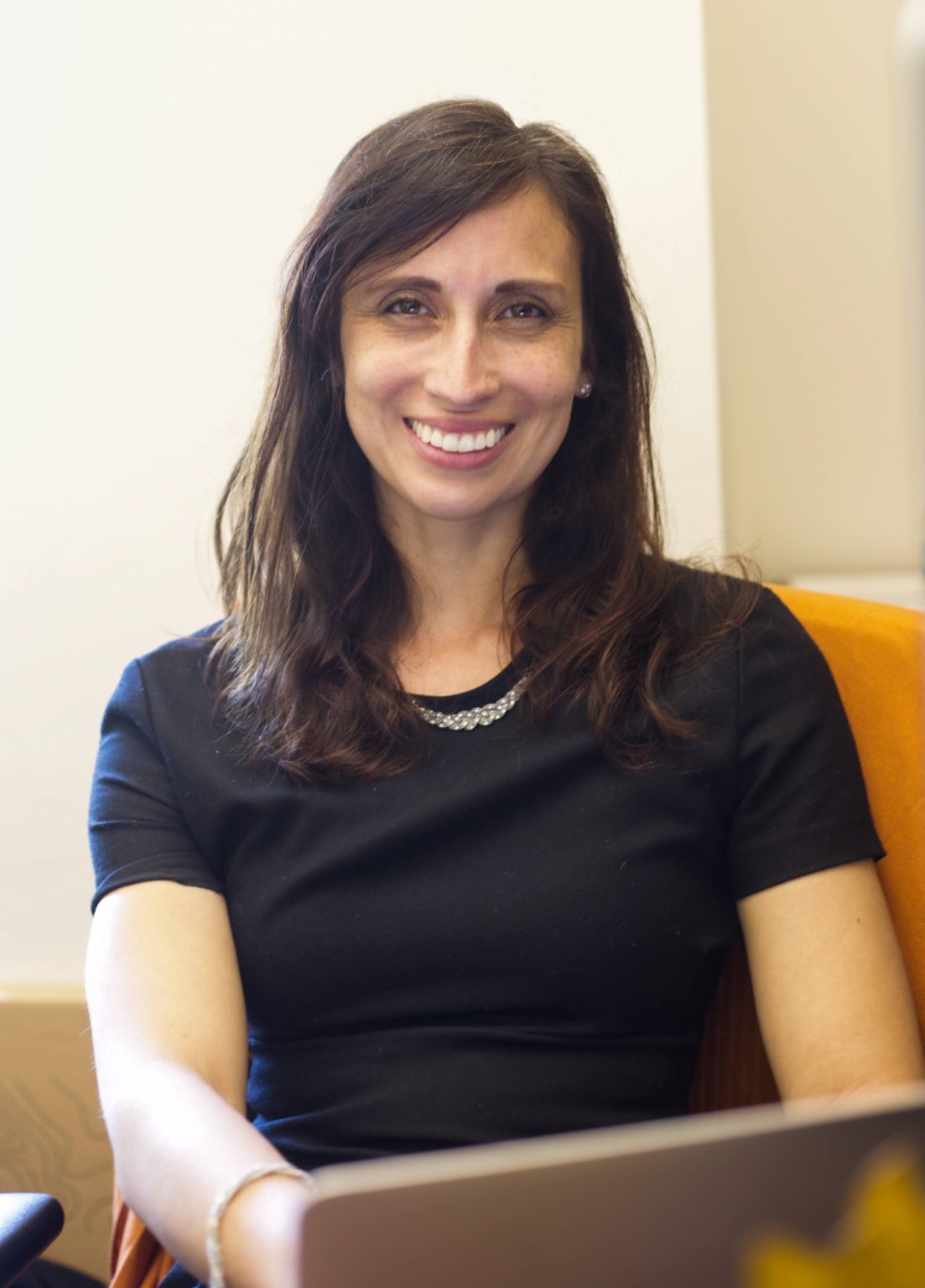 Dr. Alexandra Grabow smiles at the camera while working at her office.