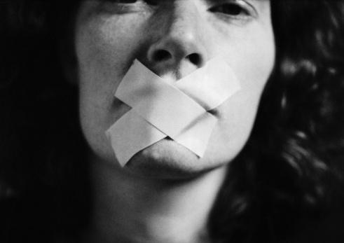 Gagged woman, close-up, blurred via Getty Images