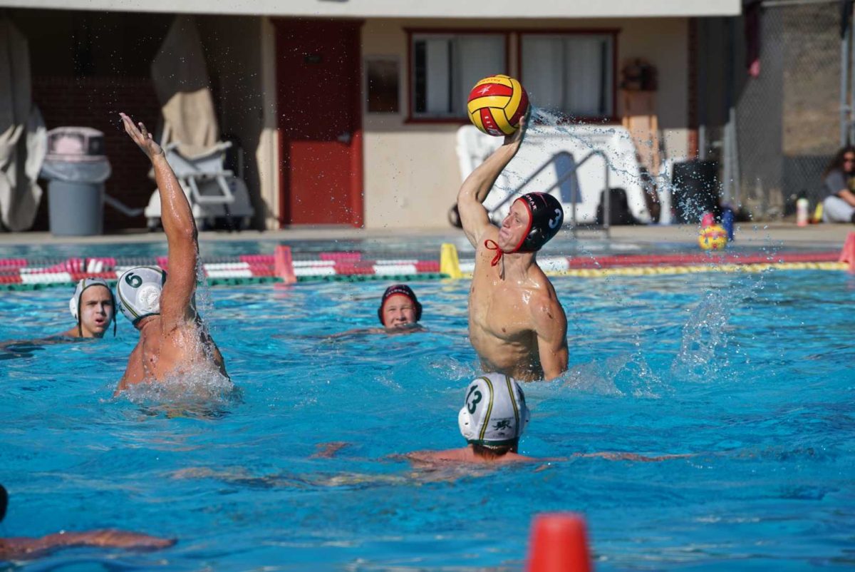 Palomar Sophomore, conference champion, and all-PCAC first team water-polo player, Arleigh Williams, throws the ball over a defending player. Photo credit: Miguel Cruz