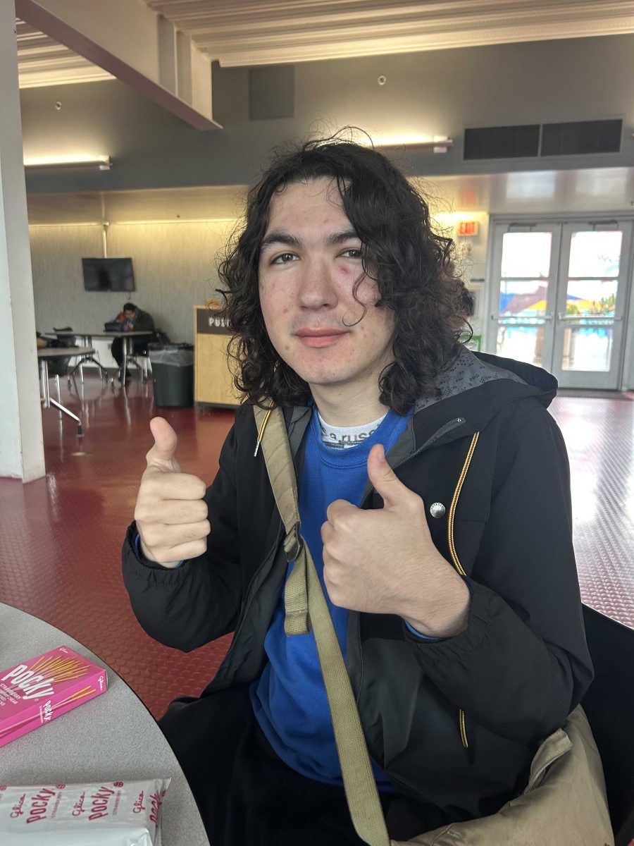 AJ Flores gives two thumbs up to the camera while taking a break in the Student Union. Photo credit: Johnny Keeling