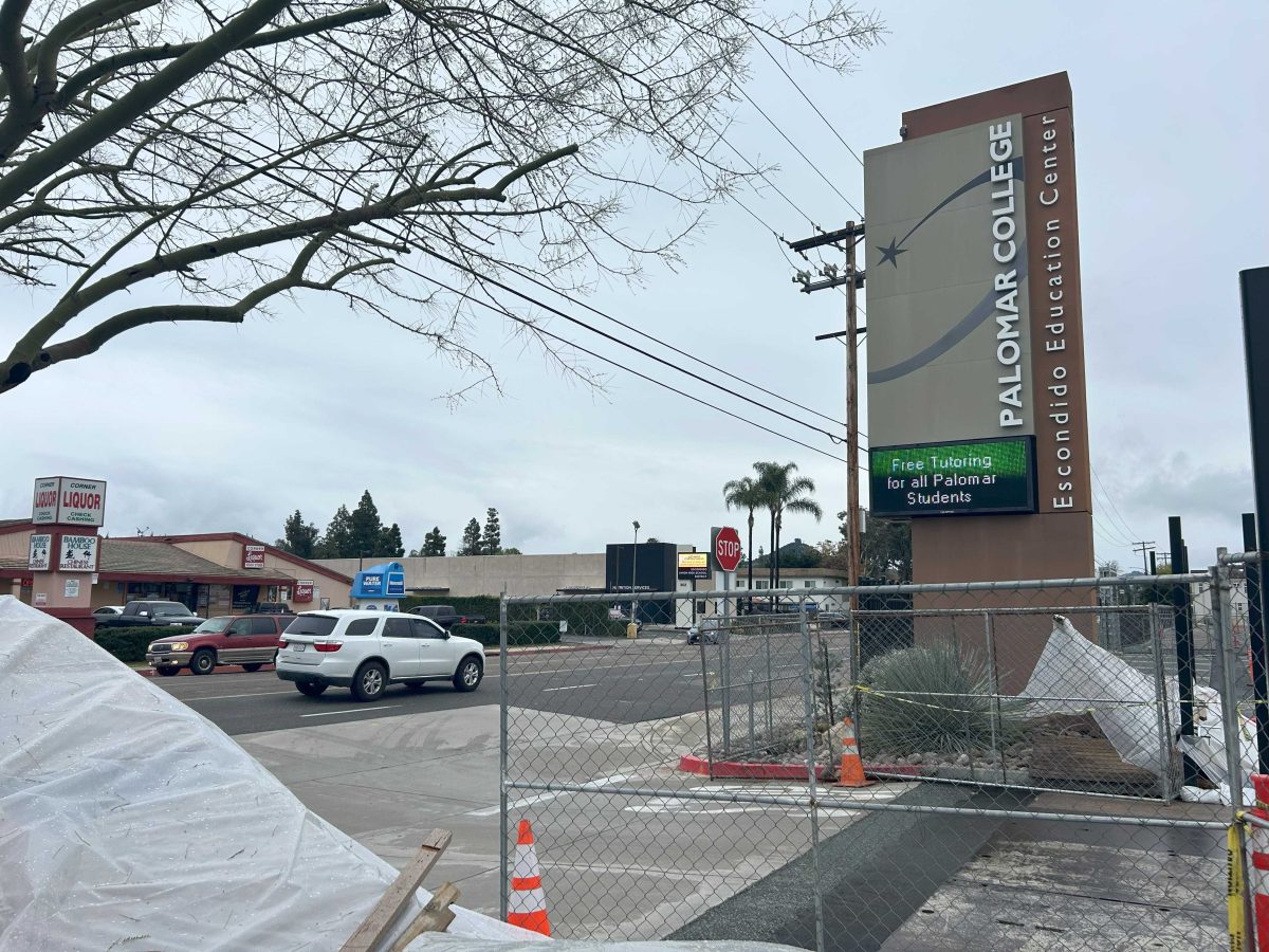 Construction supples and a fence wrap around an entrance Palomar's Escondido Education Center.