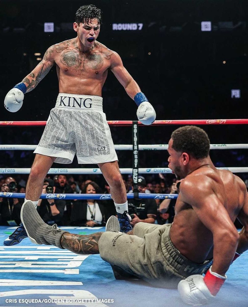 Ryan Garcia standing over Devin Haney after knocking him down during the seventh round of super lightweight boxing match. Photo credit: Cris Esqueda/Golden Boy Getty Images