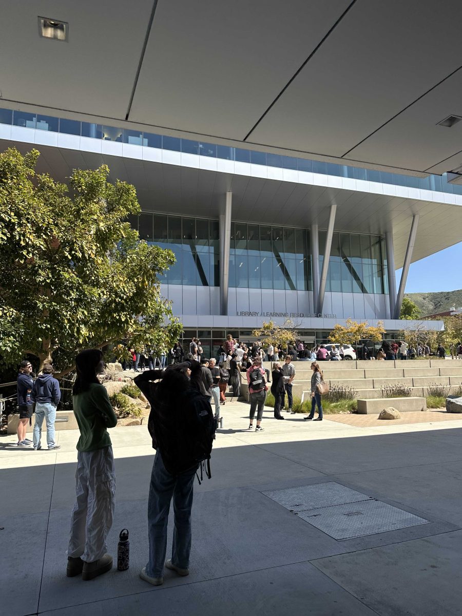 students scattered standing in front of Palomar Library Photo credit: Kaylin Garcia