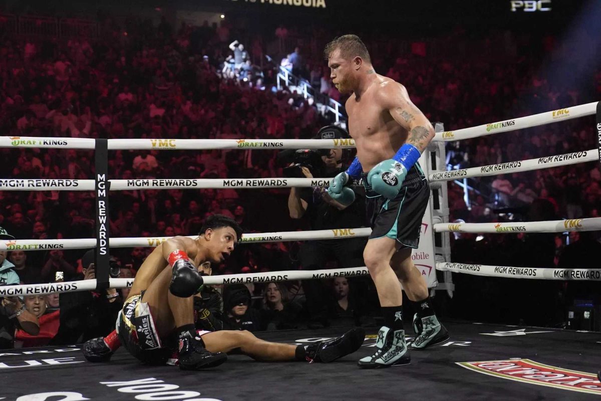 Canelo Álvarez, right, knocks down Jaime Munguia in the fourth round of their super middleweight title fight in Las Vegas on Saturday night. (John Locher / Associated Press)