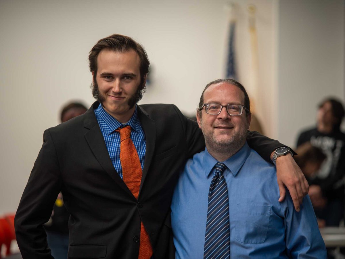 Zac Dybeck and Professor Branden Whearty pose after finishing their debate on whether or not STEM degrees are overvalued. Photo credit: Josh Miranda