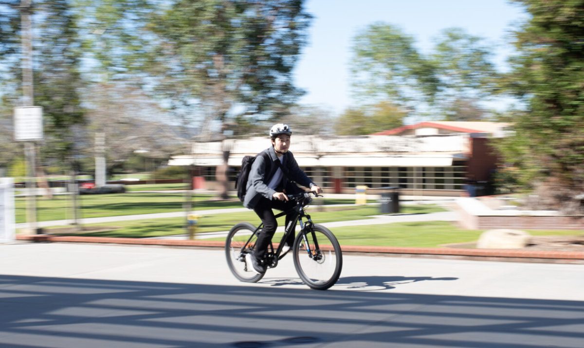 Sota Kurosaki, Palomar international student, rides his bicycle on campus, his main mode of transportation.  Tuesday, April 16, 2024.  (Photo credit: Charles Rambo/IMPACT Magazine).