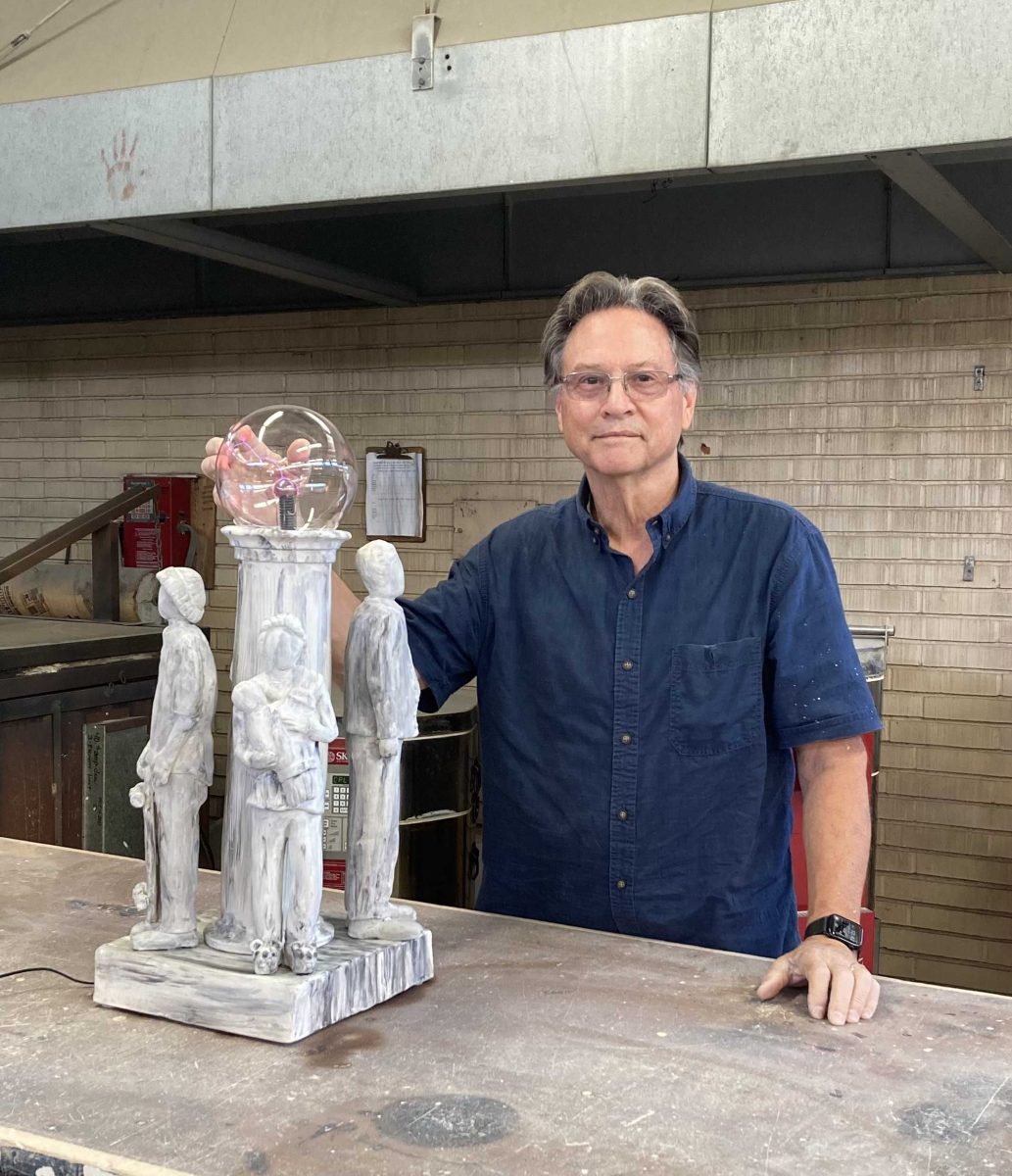 Ceramic artist Thomas Kihneman and his piece, "Many Worlds, Many Lives". Photo credit: Yanna Baradin