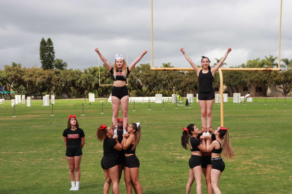 The Palomar College Cheerleading team performs a quick stunt on the practice football field at the San Marcos campus Photo credit: Alex Ortega