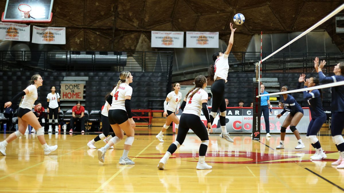 #6 Teiora Tinoisamoa jumping to hit the ball over the net.