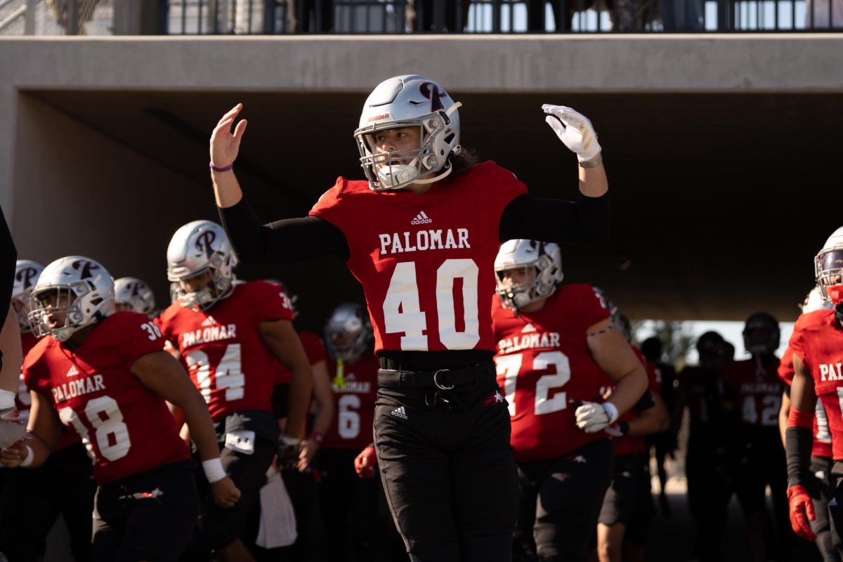 Kicker #40 Jonathon Meyers runs out of the tunnel before the game.