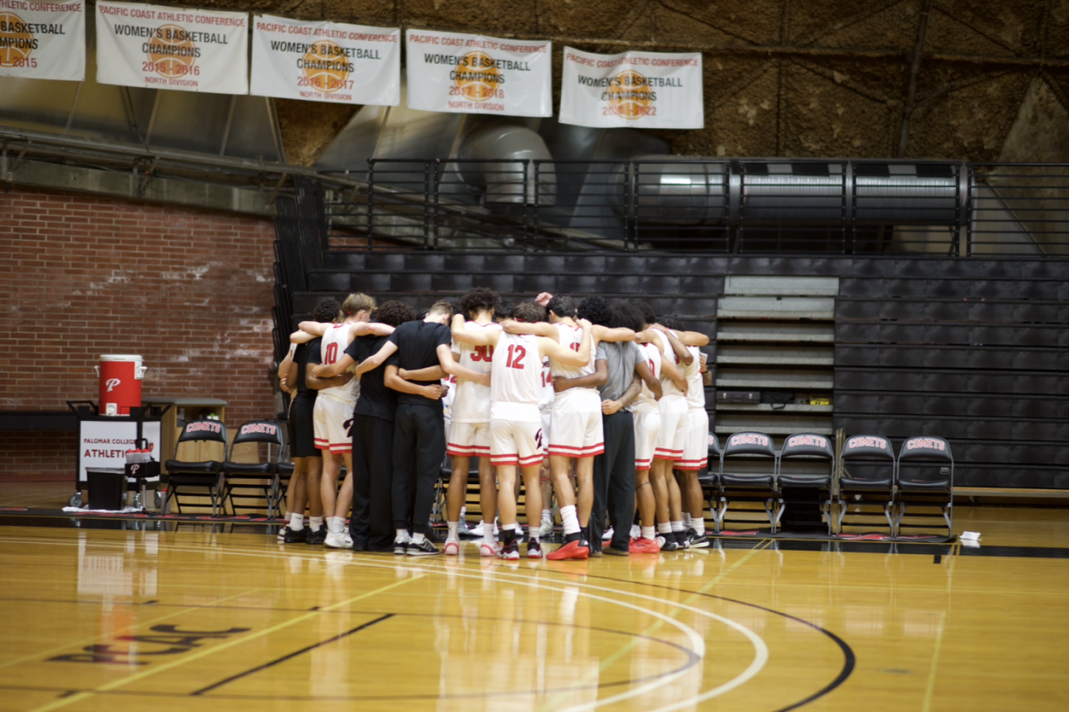 Men's basketball team huddled up before the game