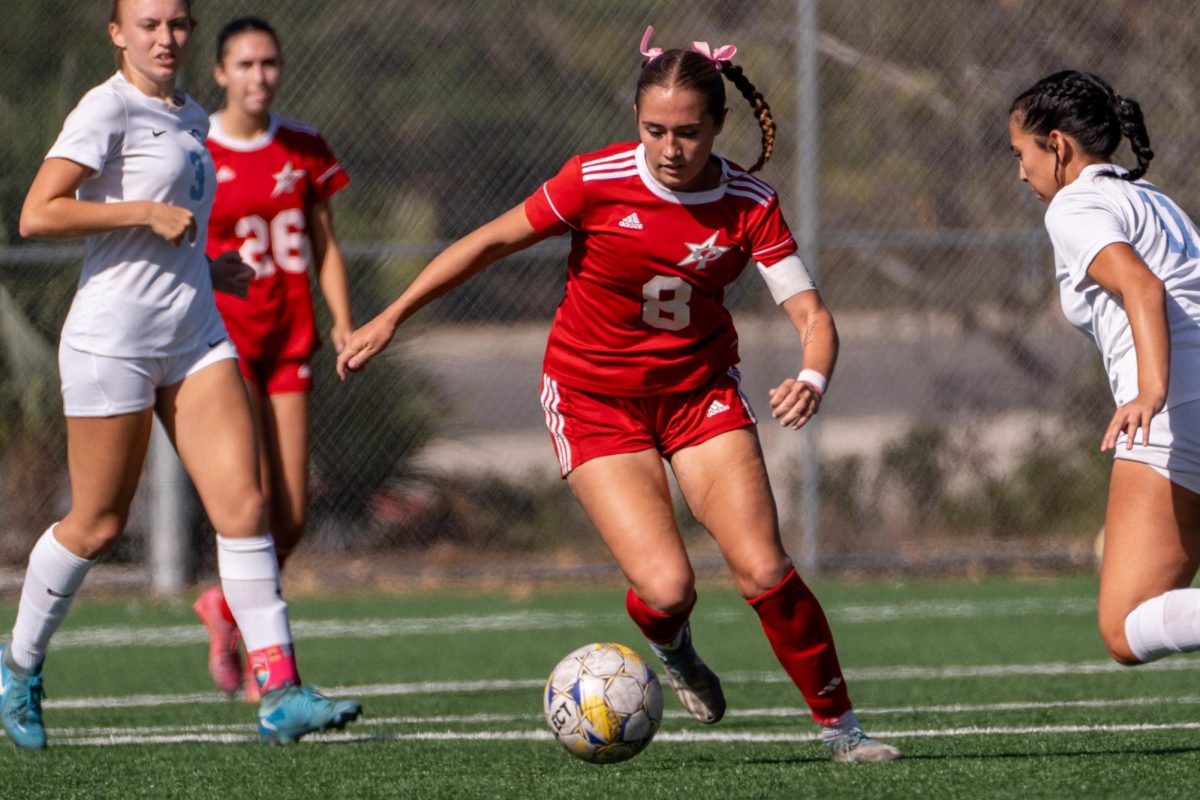 Palomar's women's soccer team captain #8 Ashley Clark gets past a defender against Miramar College on October 18, 2024.