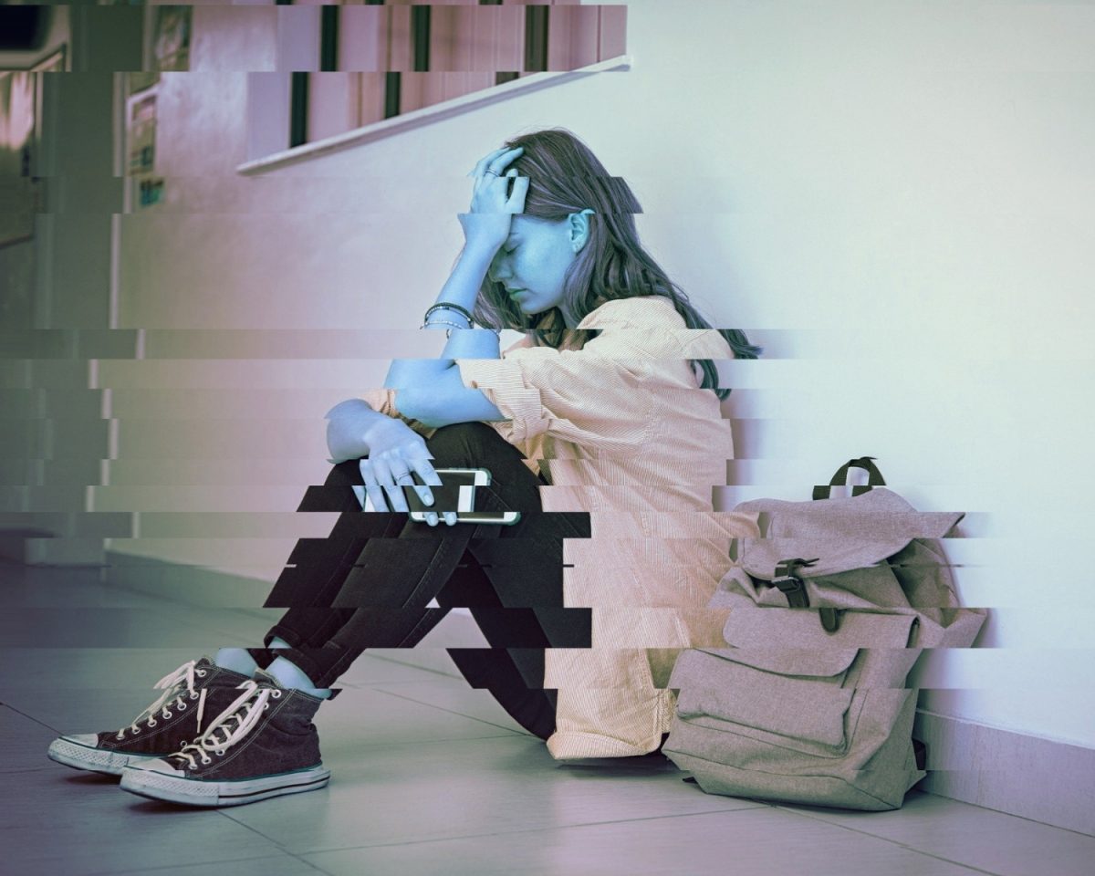 A distorted image of a student sitting against a wally with a backpack next to them, created to illustrate the mental health struggles of students. (Created on Canva by Tori Gudmundson)