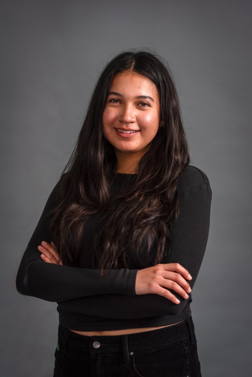 Sofia Alvarez wears black clothing and smiles at the camera.