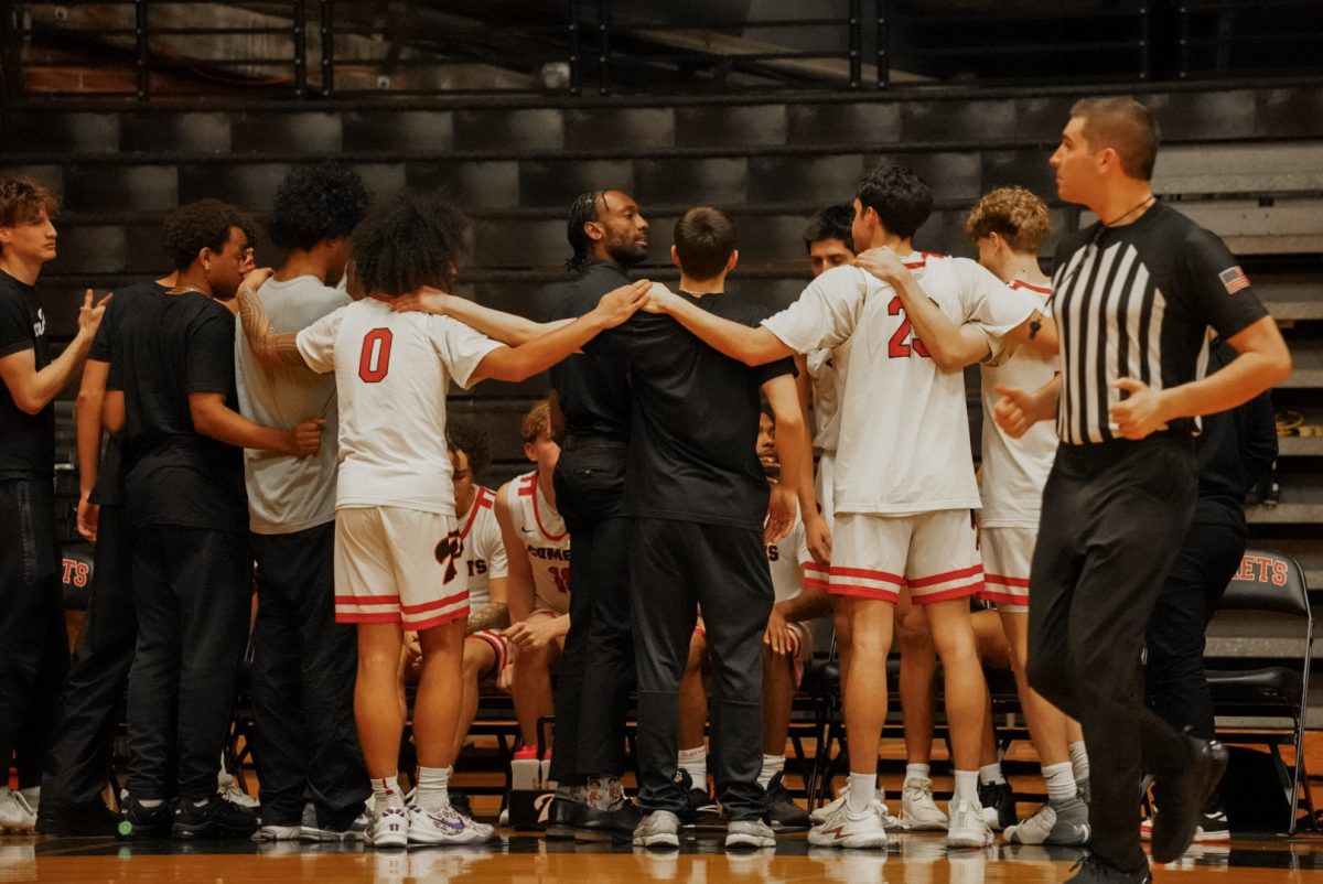 Palomar men's basketball team huddled up. 