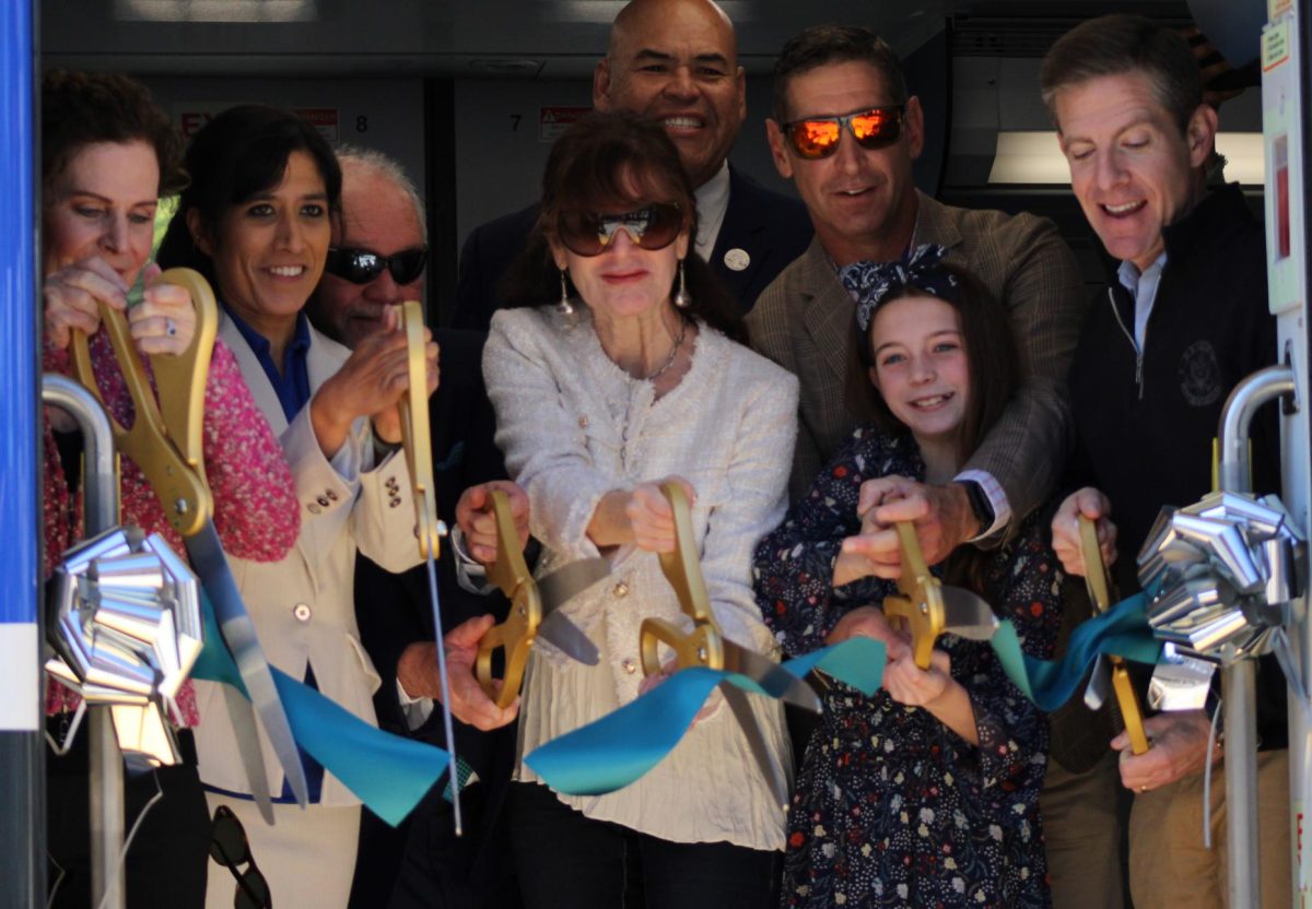 From left to right: Solana Beach Mayor and SanDag Board Chair Lesa Heebner, Mayor Pro Tempore and Carlsbad NCTD Board Chair Priya Bhat-Patel, Chief Operations Officer Tom Tulley, Deputy Mayor City of Escondido Joe Garcia, board member, Council Member City of Encinitas Jim O'Hara and his daughter, and U.S. Representative Mike Levin in a ribbon cutting ceremony to celebrate the new COASTER cars.