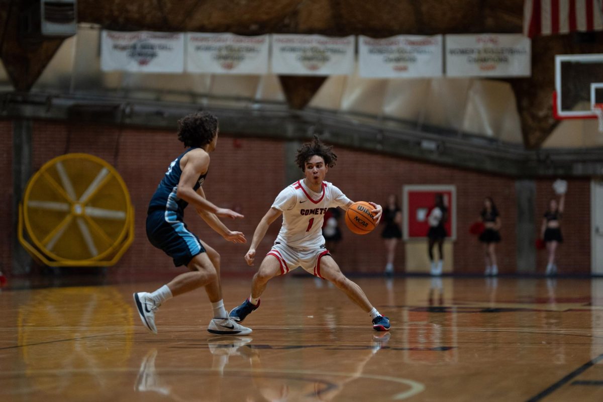 #1 Isaiah Tolmaire attempting to drive past a Mira Costa defender.