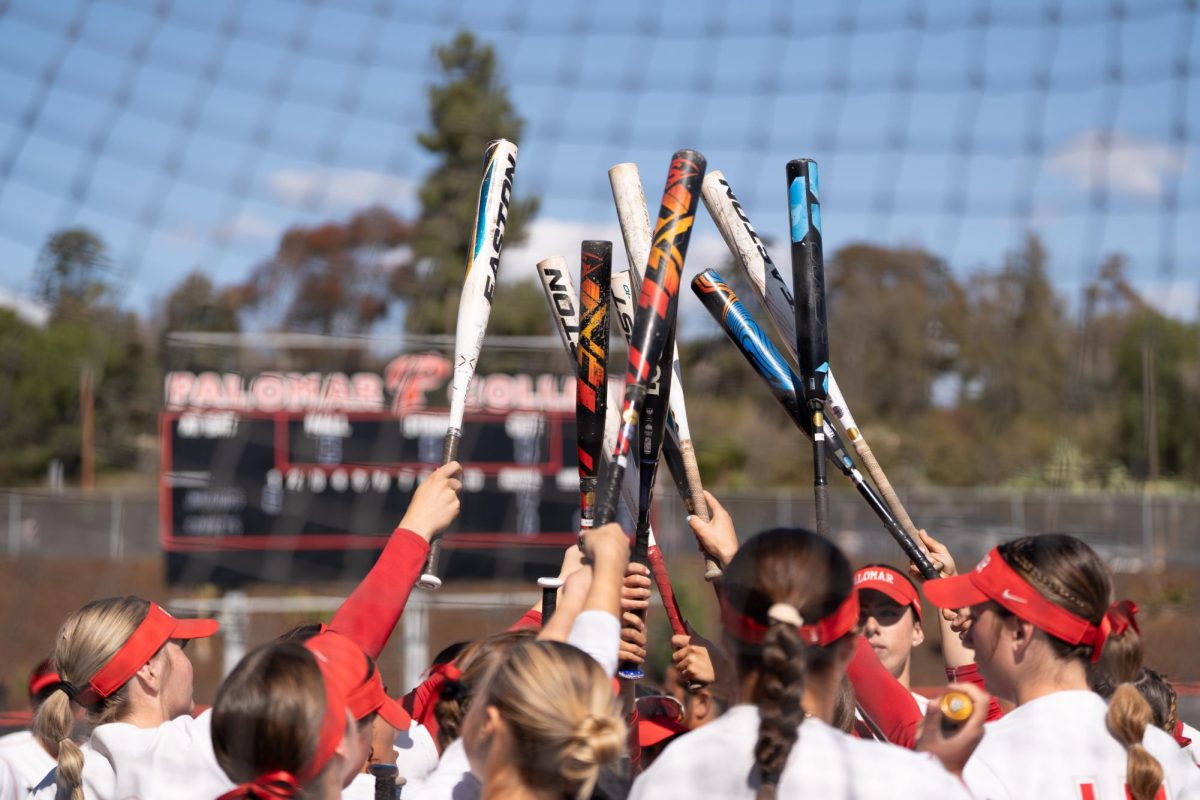 Palomar's softball team huddle before taking their first at bats against Southwestern College ,which they went on to defeat 10-1