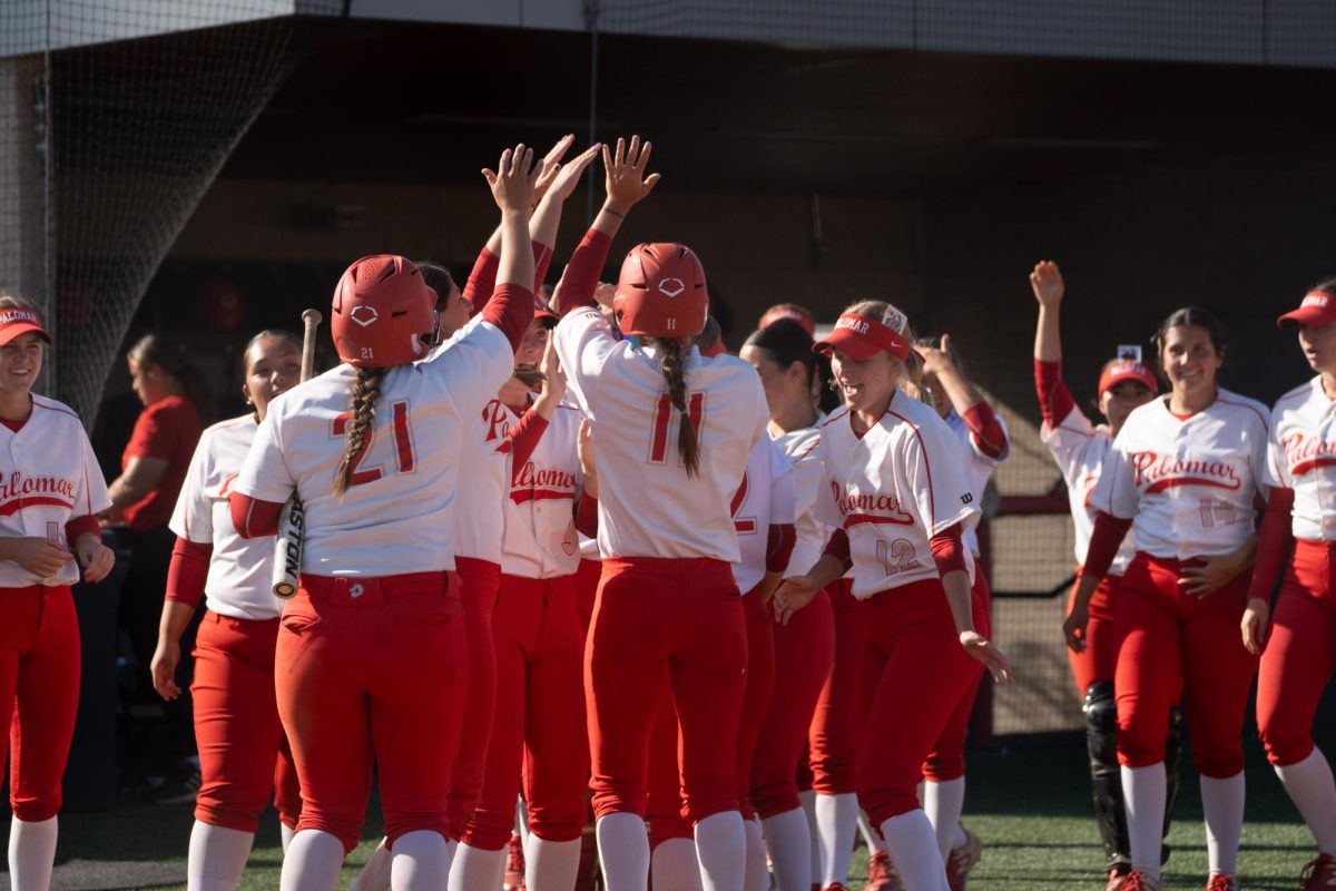 Palomar Softball celebrates after #11 Josephine Heuberger's walk-off hit win against San Diego Mesa College. 
