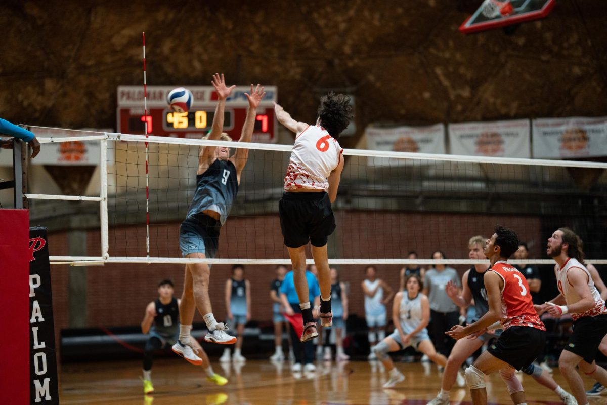 Palomar's opposite hitter #6 Tyler Yraceburn (left) spikes the ball past Miramars #9.