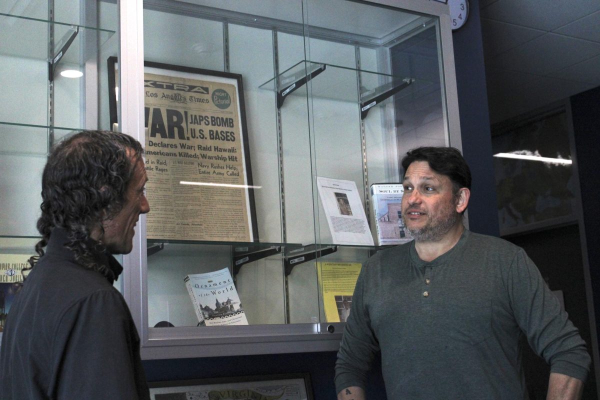 Jason Pache, left, a staff writer for The Telescope, speaks with Peter Bowman, a political science professor at Palomar College, during a Q&A about the uncertainty of democracy under the Trump administration.