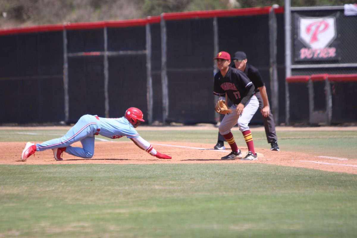 #3 Justin Tucker dives back to first base on a pick-off attempt to #17 Adrian Roman
