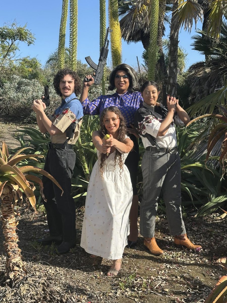 The cast of "Bad Hombres, Good Wives" pose for a picture in costume. The show highlights narco-novela comedic influences and cultural diversity. (Photo courtesy of Palomar Performing Arts).
