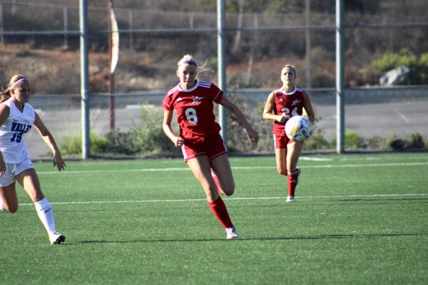 Emma Gryn is racing to get control of the ball before the player on her left from San Bernardino Valley captures it.