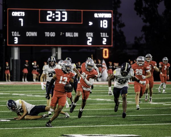 Palomar College's Bubba Garcia (#13), wearing a red uniform and silver helmet, returns the ball from a kickoff late in the second quarter against San Diego Mesa College on Sept. 20, 2025 at Palomar College Stadium.