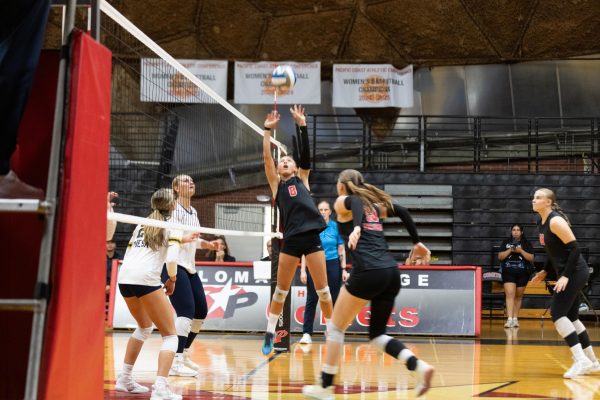 Caden Pinto (#8) is leaping to set the ball for her teammate Sierra Schoenwald (#13) to spike in the first set against San Diego Mesa on Sept. 19, 2025 in the The Dome.
