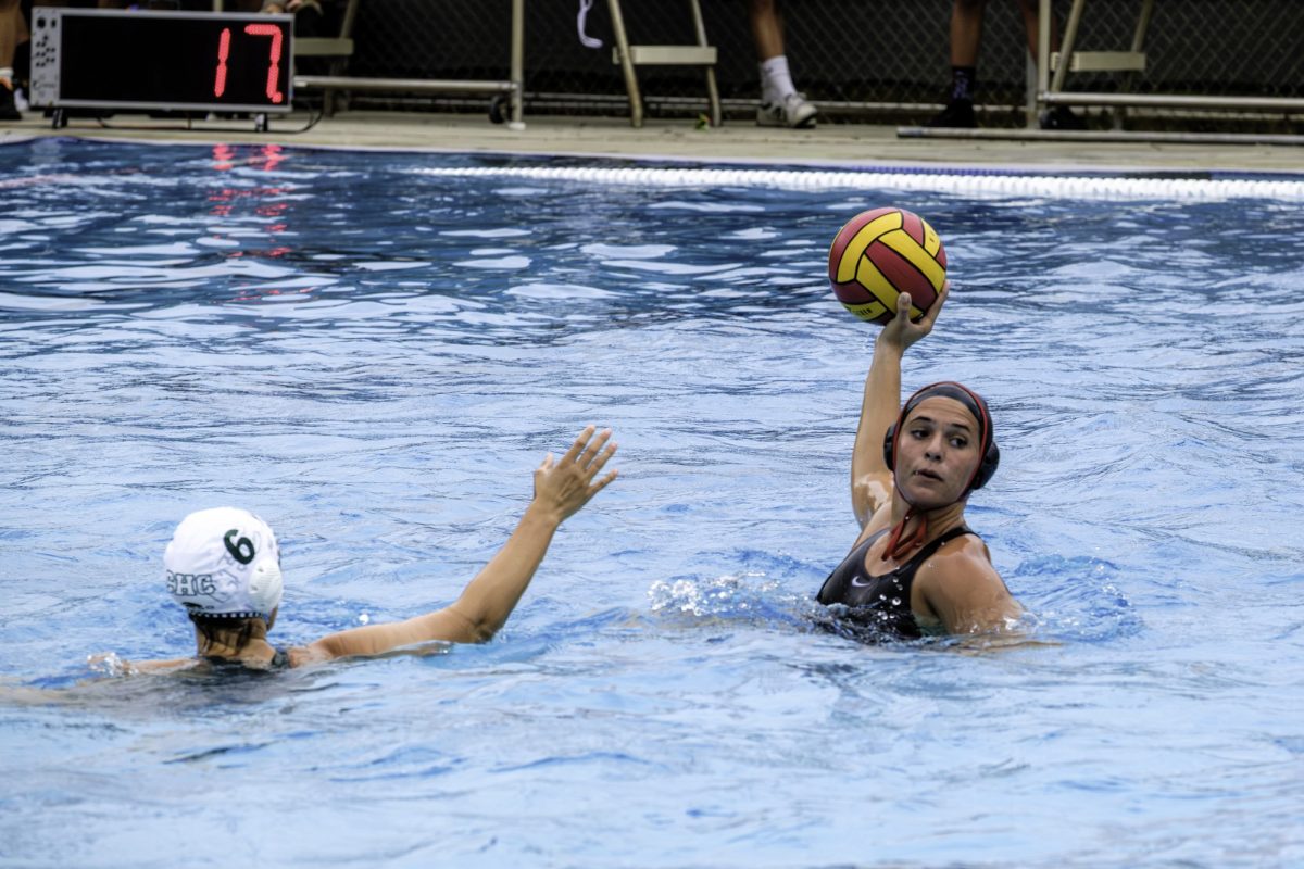 Palomar College's Renne Provencal (#8) has her arm up with a red and yellow ball, getting ready to throw it.