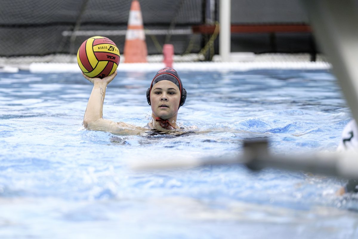 Palomar College's Malia Hanss (#12) is looking for an open player to throw the red and yellow ball.